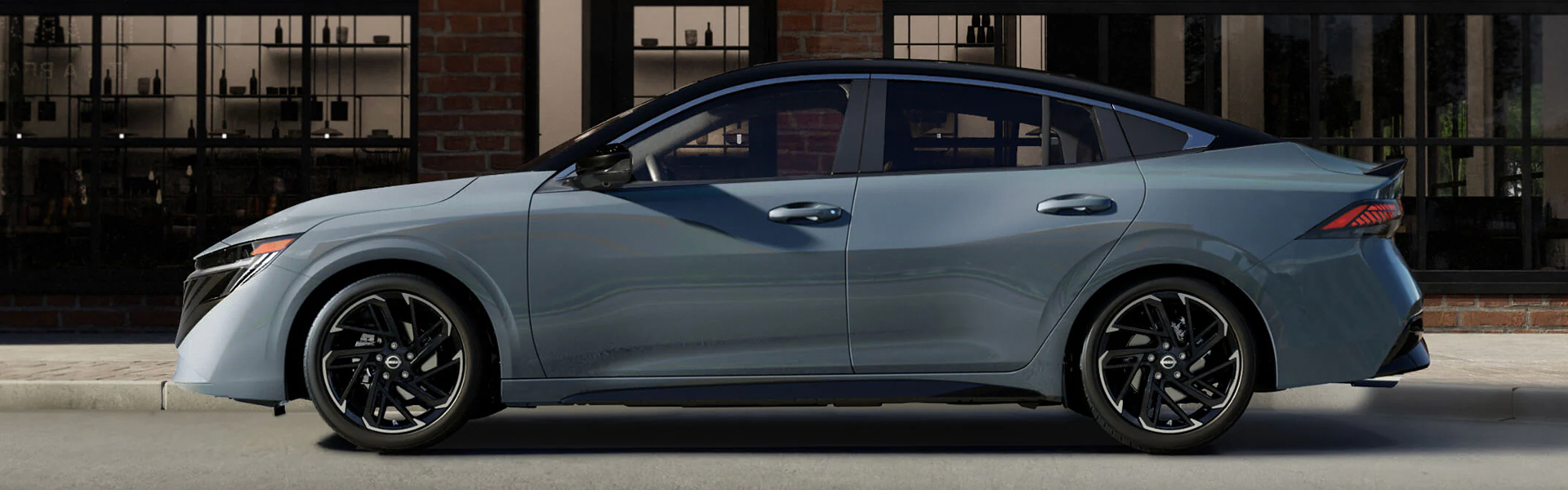 Gray Nissan sedan parked on a city street